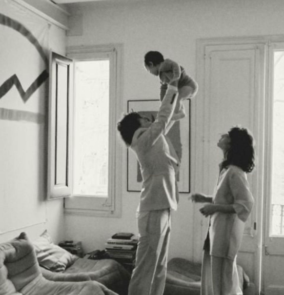 Parents playing with their child in a light-filled room